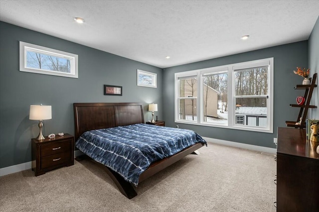 bedroom with carpet, baseboards, and a textured ceiling