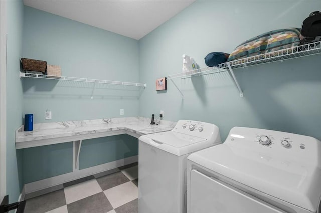 clothes washing area with laundry area, washer and clothes dryer, and tile patterned floors