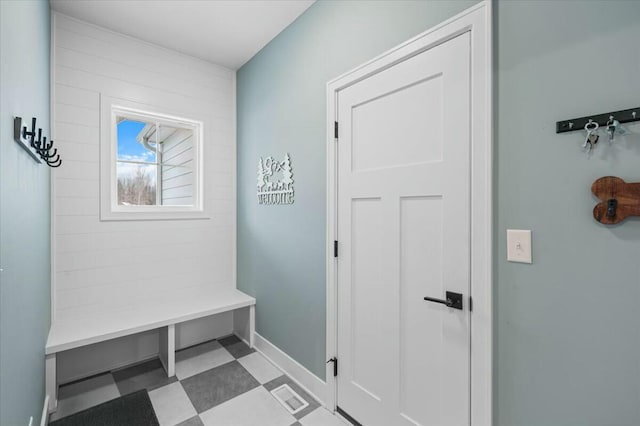 mudroom featuring baseboards, visible vents, and tile patterned floors