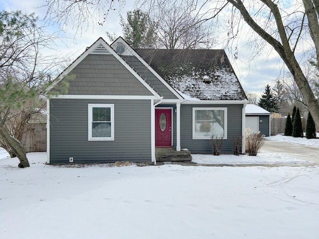 view of front of property featuring a garage and an outdoor structure