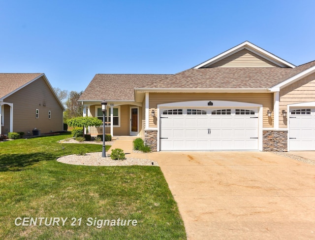 100 Tuscany Cir, Saginaw, MI 48603 - view of front of home featuring stone siding, an attached garage, concrete driveway, a front lawn, and roof with shingles