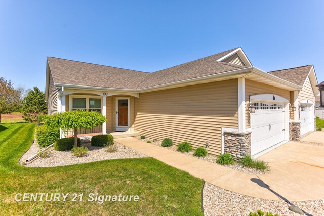 100 Tuscany Cir, Saginaw, MI 48603 - view of front of property featuring an attached garage, concrete driveway, a front yard, roof with shingles, and stone siding