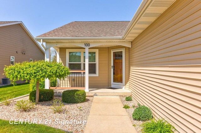 100 Tuscany Cir, Saginaw, MI 48603 - doorway to property with covered porch, roof with shingles, and central AC unit