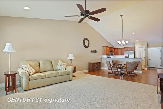 100 Tuscany Cir, Saginaw, MI 48603 - living area with a chandelier, baseboards, vaulted ceiling, light carpet, and recessed lighting