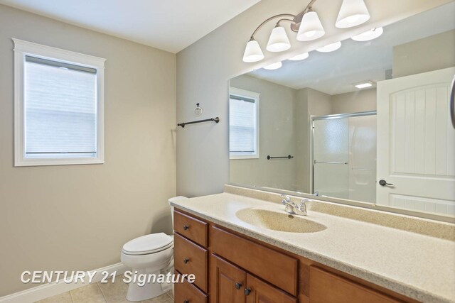 100 Tuscany Cir, Saginaw, MI 48603 - bathroom featuring a shower stall, toilet, vanity, tile patterned flooring, and baseboards