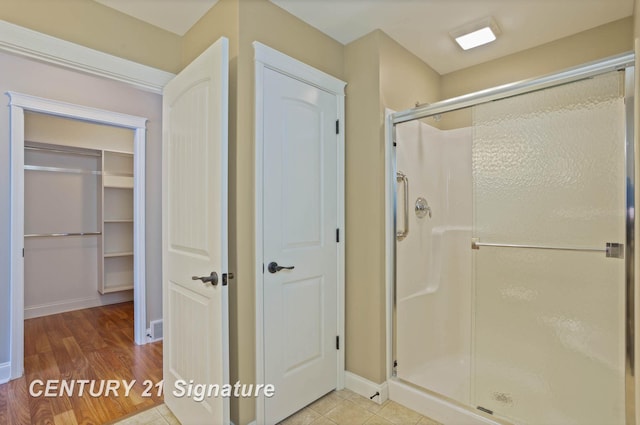 100 Tuscany Cir, Saginaw, MI 48603 - full bathroom with a stall shower, baseboards, a closet, and wood finished floors