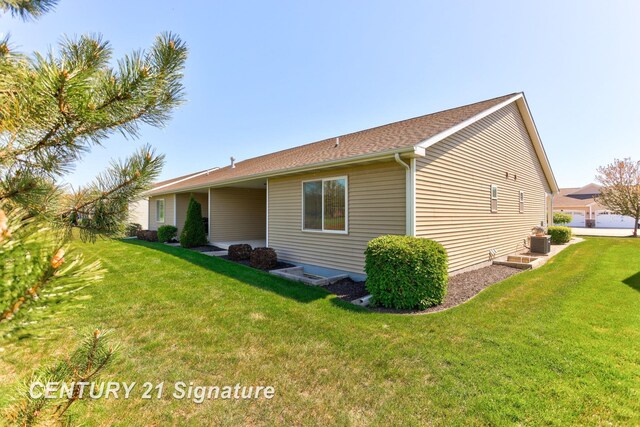 100 Tuscany Cir, Saginaw, MI 48603 - view of home's exterior featuring a yard and central AC unit