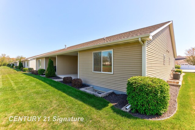 100 Tuscany Cir, Saginaw, MI 48603 - view of side of home featuring a lawn and central air condition unit