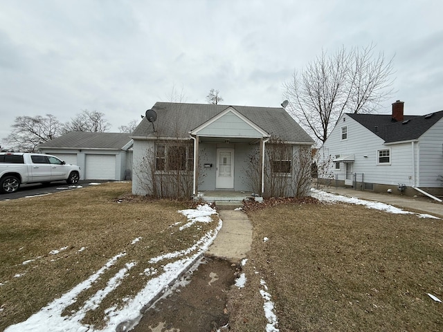 bungalow-style house with a garage and a lawn