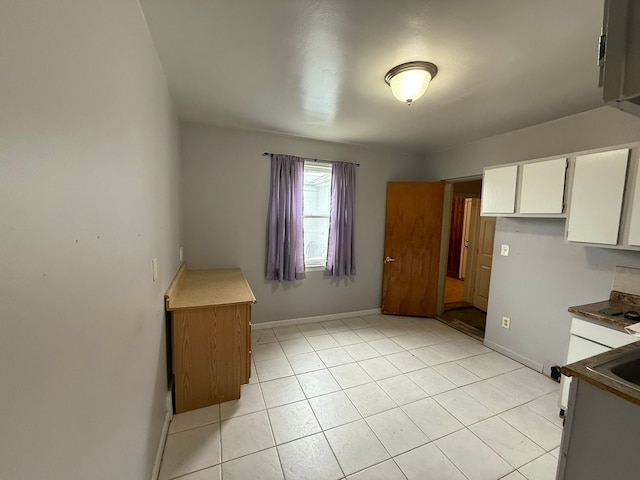5727 Merriman Rd, Garden City, MI 48135 - unfurnished dining area featuring baseboards, light tile patterned floors, and a sink