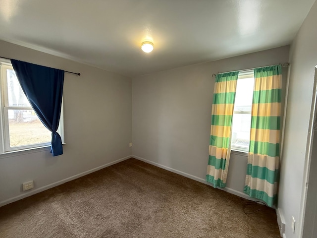 carpeted empty room with plenty of natural light and baseboards