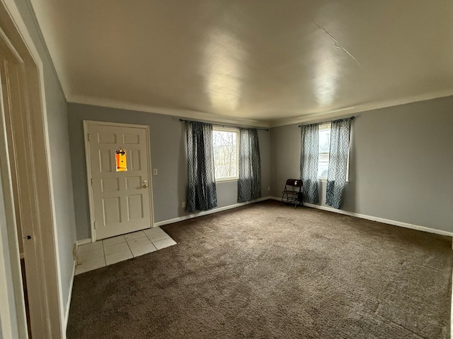 entryway featuring carpet flooring and baseboards