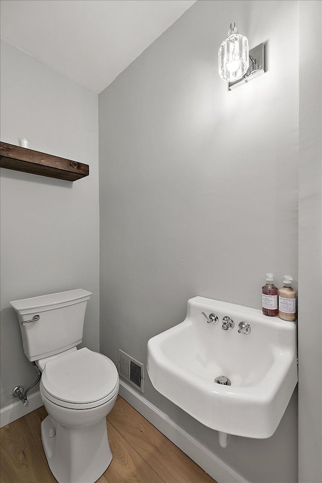 bathroom featuring hardwood / wood-style flooring, sink, and toilet