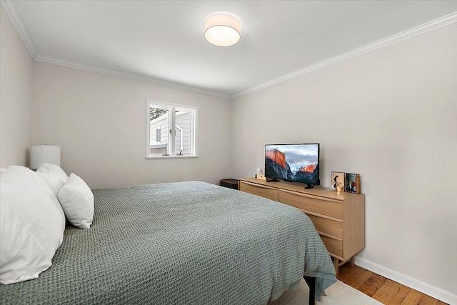 bedroom featuring hardwood / wood-style flooring and ornamental molding