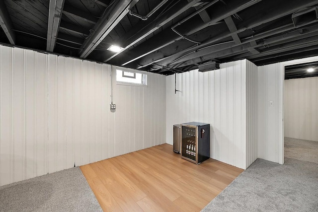 basement with hardwood / wood-style flooring