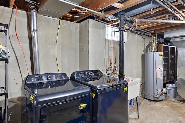 laundry area with washing machine and dryer and water heater