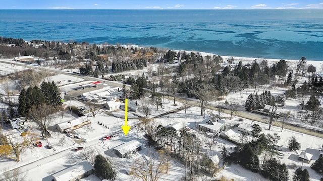 snowy aerial view featuring a water view