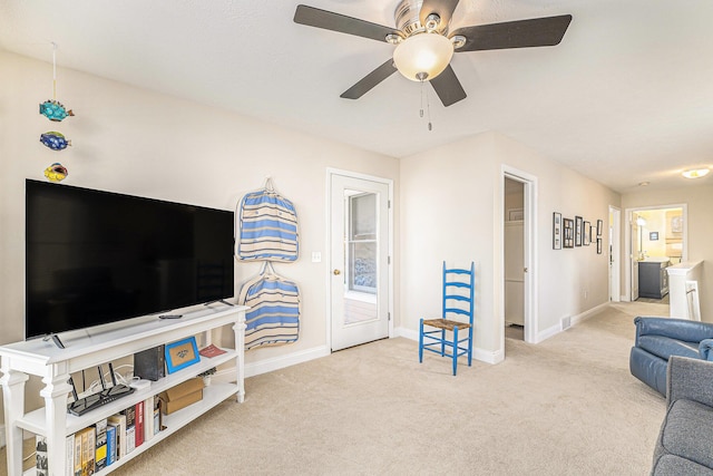 living room featuring ceiling fan and light colored carpet