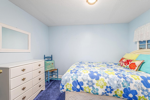 carpeted bedroom featuring a textured ceiling