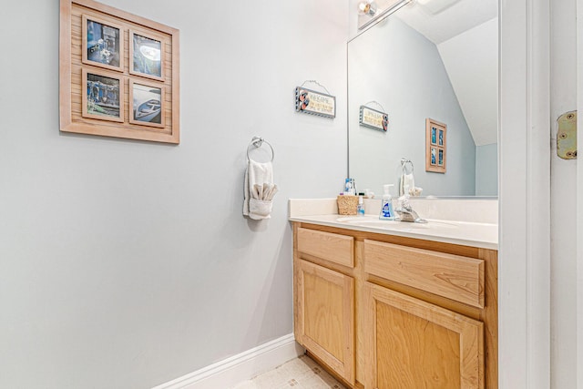 bathroom with vanity and vaulted ceiling