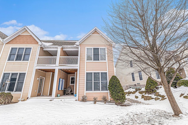 snow covered house with a balcony