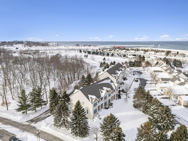 snowy aerial view featuring a water view