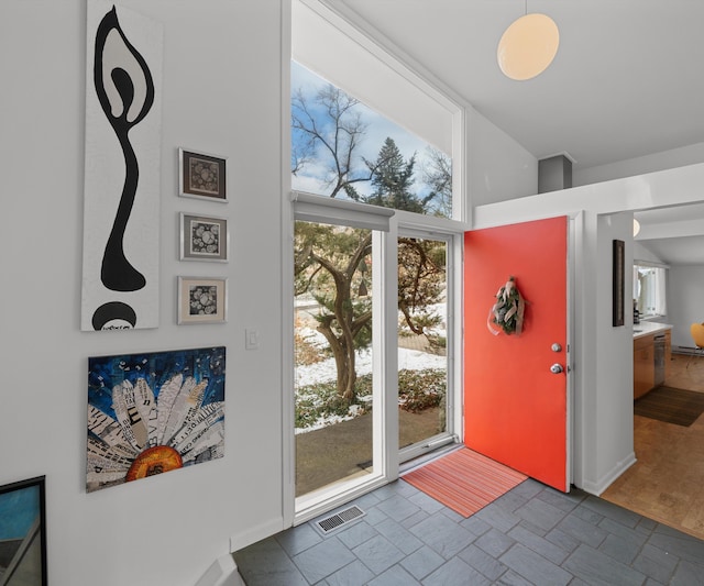 doorway to outside with floor to ceiling windows