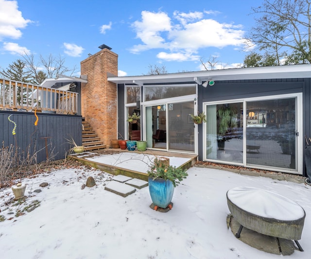 snow covered property featuring a patio area