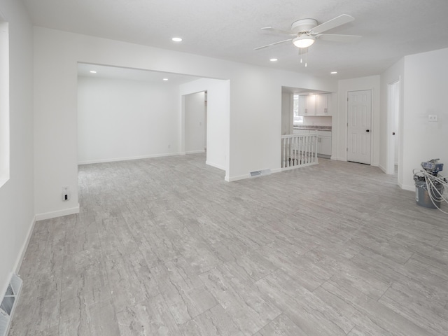 spare room featuring light wood-type flooring and ceiling fan