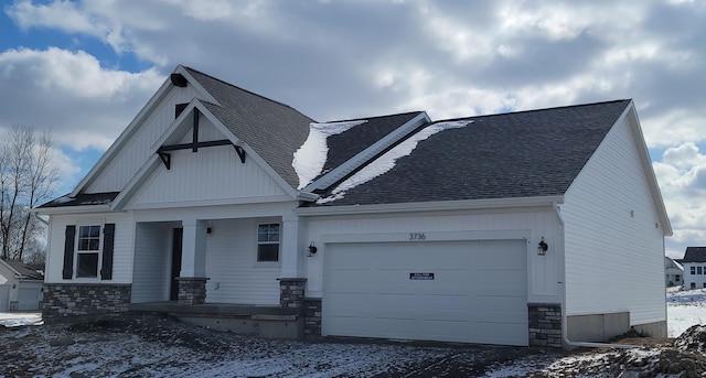 view of front facade featuring a garage and covered porch