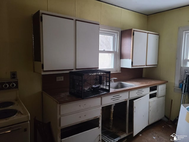 kitchen featuring white cabinetry, sink, and white electric range