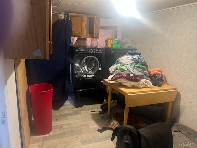 interior space with washer / dryer, laundry area, and light wood-style flooring