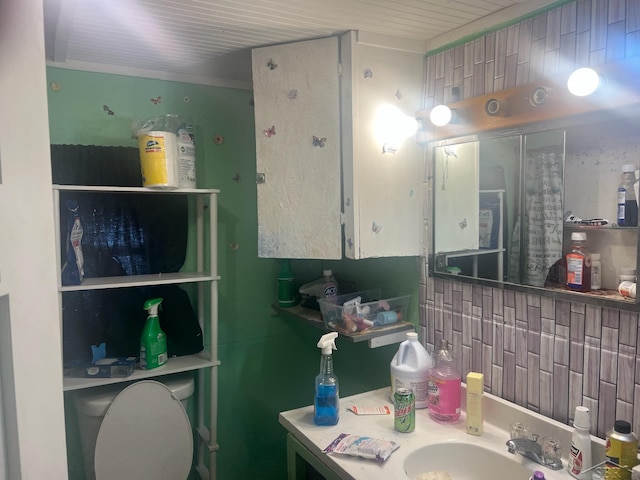 bathroom featuring backsplash and a sink