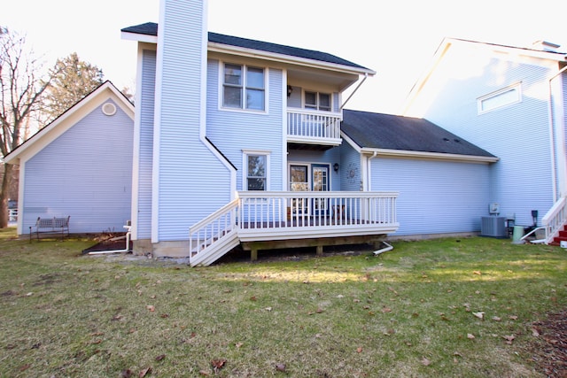 back of property with a balcony, central AC unit, a chimney, and a lawn