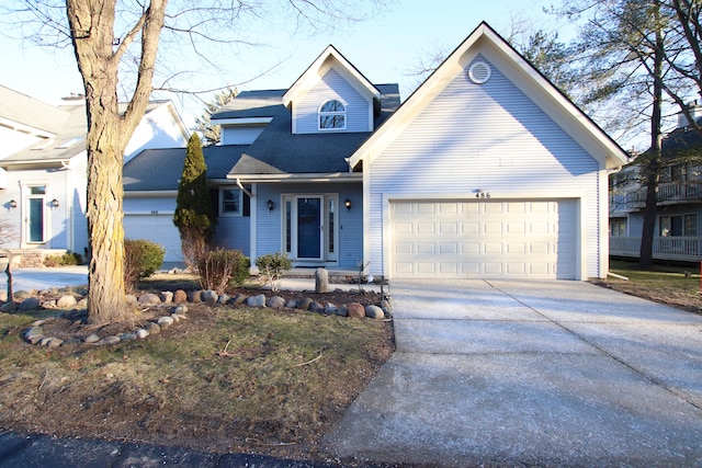 view of front of home with an attached garage, a shingled roof, and driveway