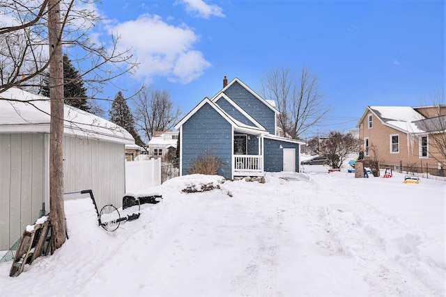 view of snow covered rear of property