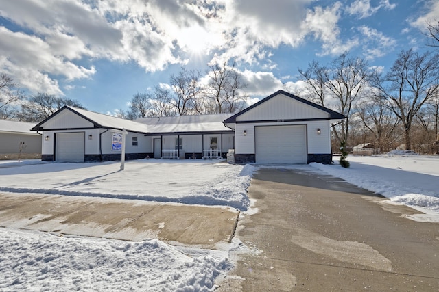 ranch-style house with a garage and covered porch