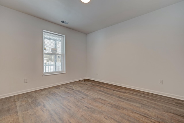 spare room with wood-type flooring