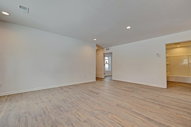 unfurnished room with light wood-type flooring