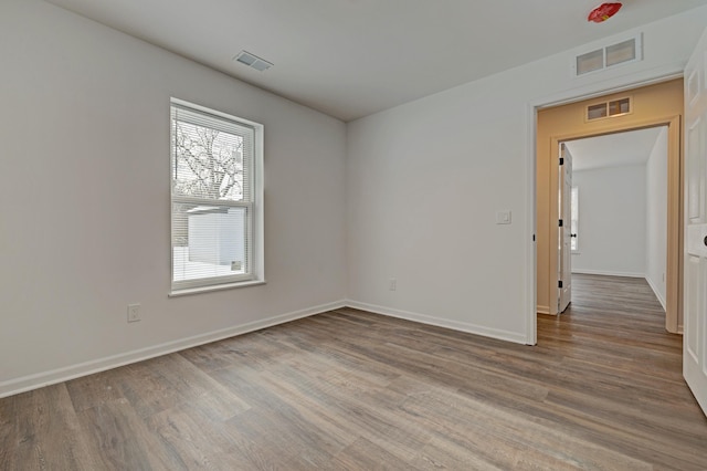 spare room with hardwood / wood-style floors