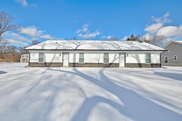 view of snow covered rear of property