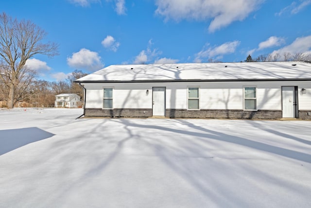 view of snow covered rear of property