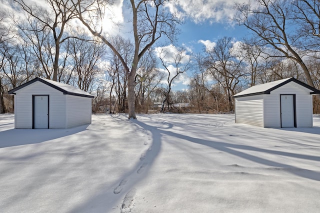 yard covered in snow with a shed