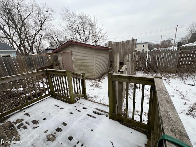 snow covered deck featuring a storage unit