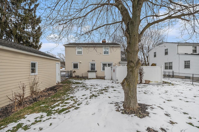 view of snow covered rear of property