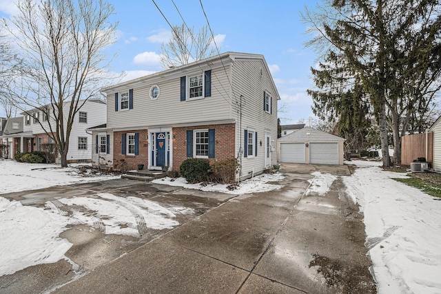 view of front of property featuring central AC unit, a garage, and an outdoor structure