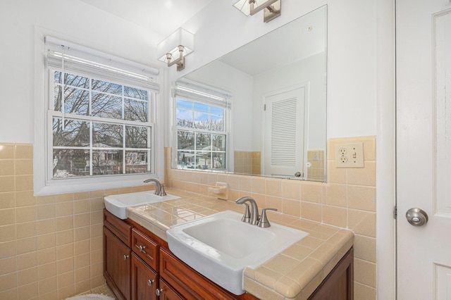 bathroom with vanity and tile walls