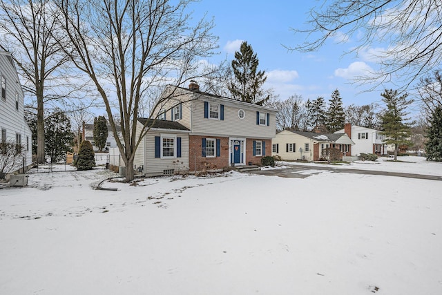 view of snow covered back of property