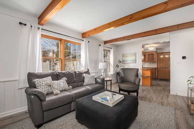 living room with beamed ceiling and dark hardwood / wood-style flooring