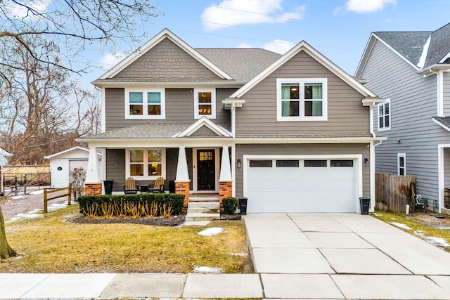 craftsman inspired home featuring driveway, an attached garage, covered porch, fence, and a front lawn